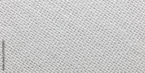 Close-up view of a piece of white fabric. Macro shot. Texture.