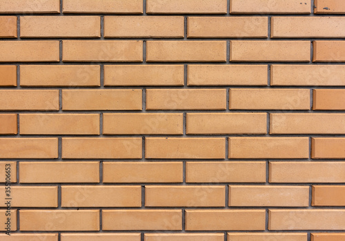 A neatly laid out brick wall. Brickwork.