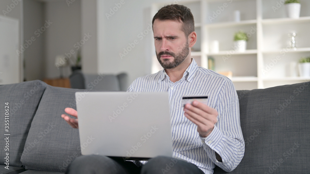 Young Man having Online Payment Failure on Laptop at Home Young Man having Online Payment Failure on Laptop at Home