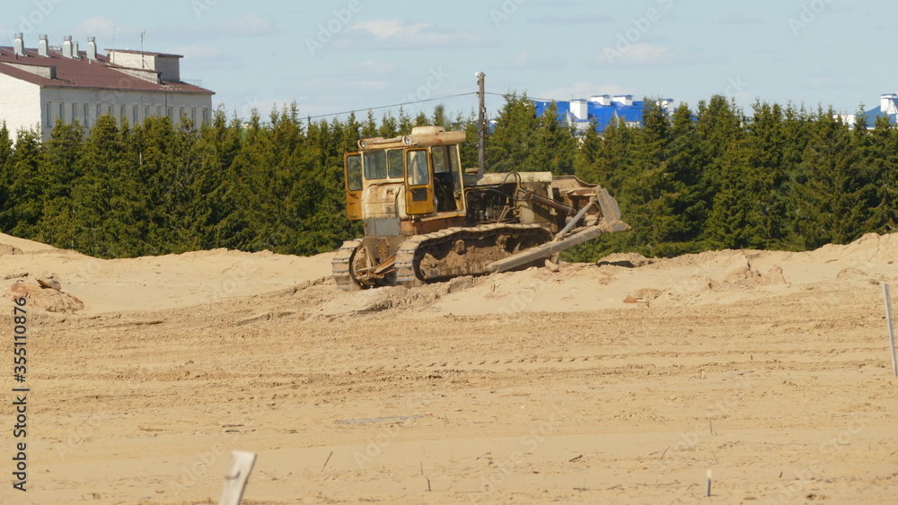 a bulldozer levels the territory for construction