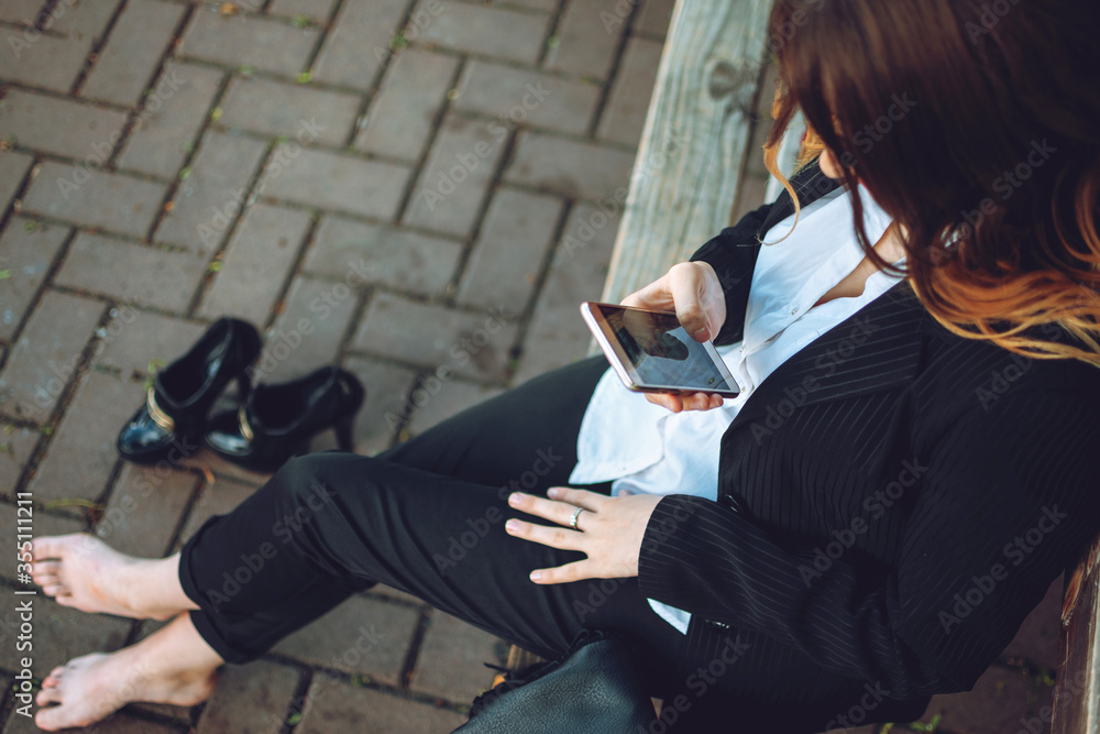 Fototapeta premium Office worker business woman working and holding online meetings in the park outside. Safe workplace outdoor, safe work space for the post-pandemic era