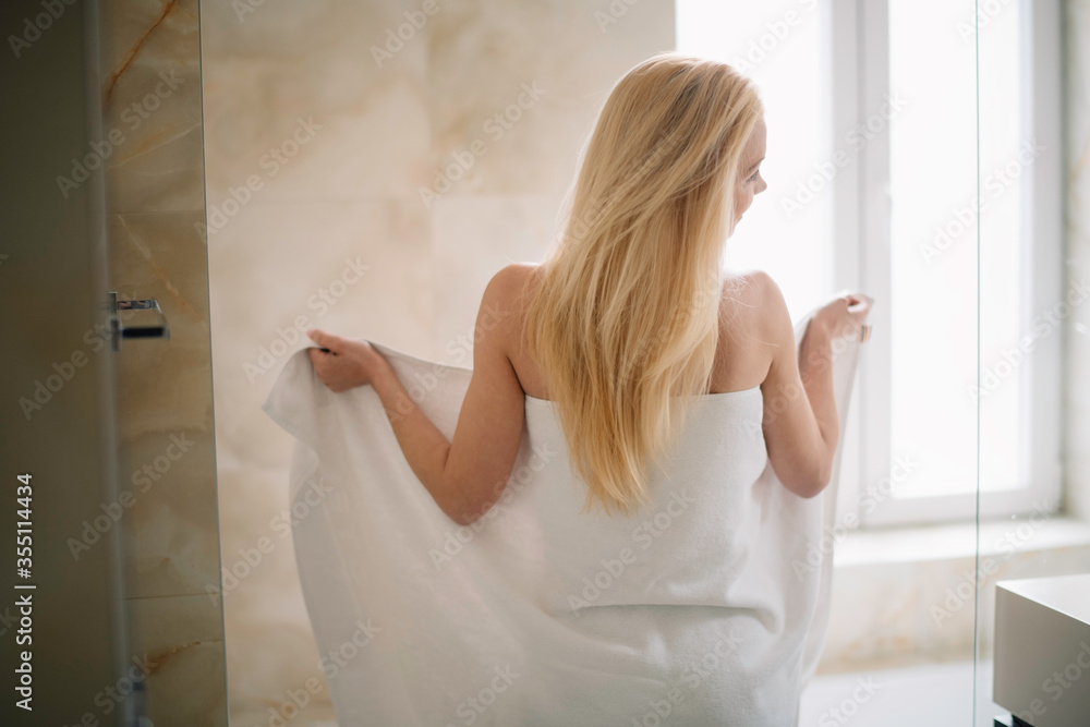 Beautiful woman wearing a bathrobe. Young happy woman enjoing in hotelroom. Beautiful woman wearing a bathrobe. Young happy woman enjoing in hotelroom.