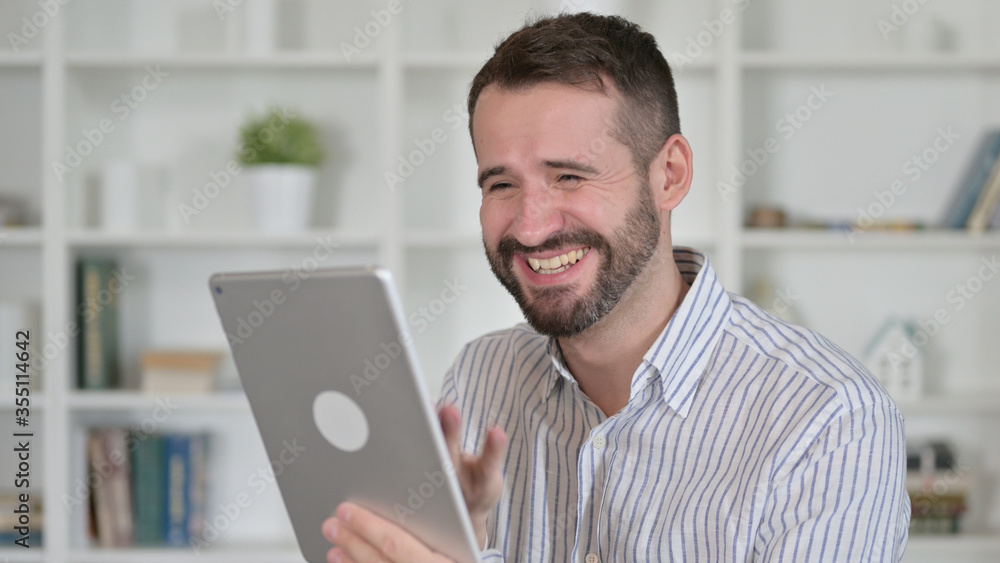 Portrait of Young Man Celebrating Success on Tablet Portrait of Young Man Celebrating Success on Tablet