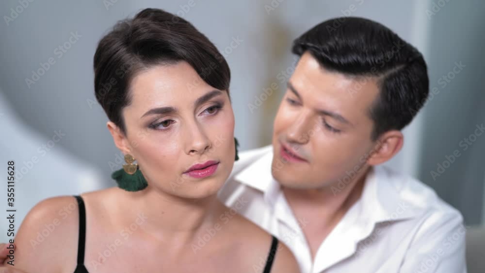 Young Romantic Couple Is Looking At Each Other's Eyes And Speaking. They Are In Love. The Concept Of Love And Tenderness. Young Romantic Couple Is Looking At Each Other's Eyes And Speaking. They Are In Love. The Concept Of Love And Tenderness.