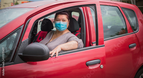 Social distance concept. Life people after quarantine. Middle aged plus size lady wear protective mask at street 