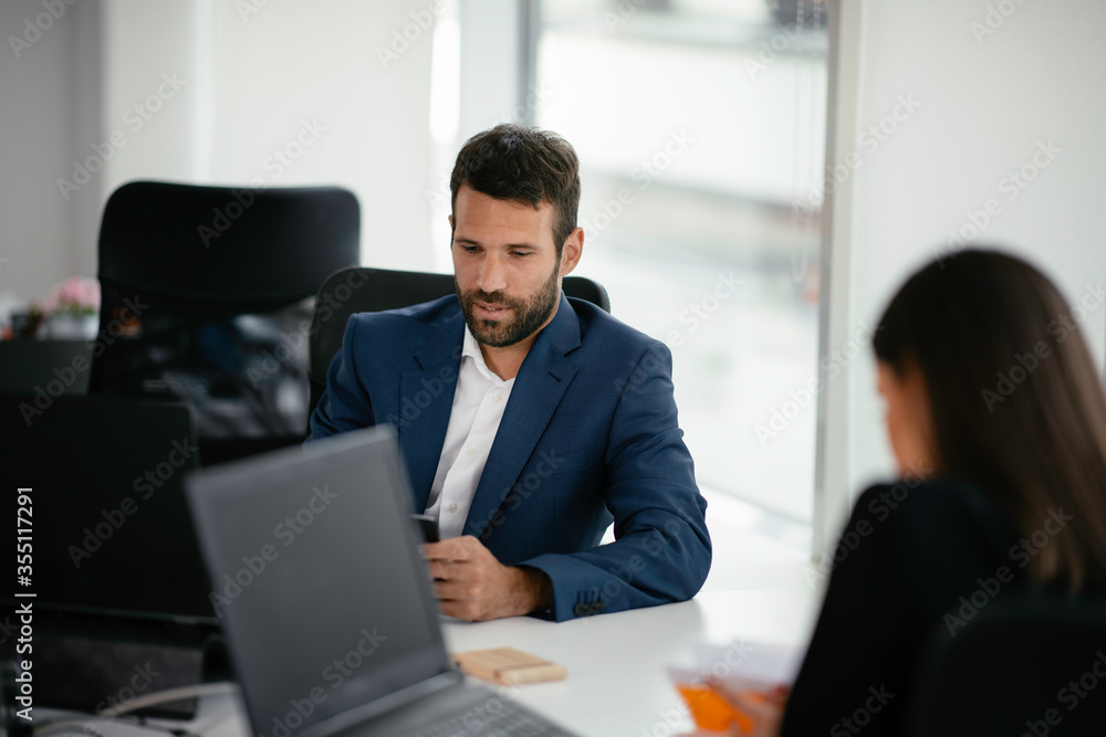 Businessman working on a project in the office. Young businessman working in office. Businessman working on a project in the office. Young businessman working in office.