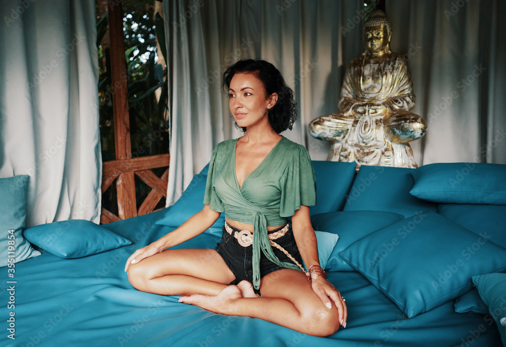 Fototapeta premium Woman meditation with Buddha fashion yoga