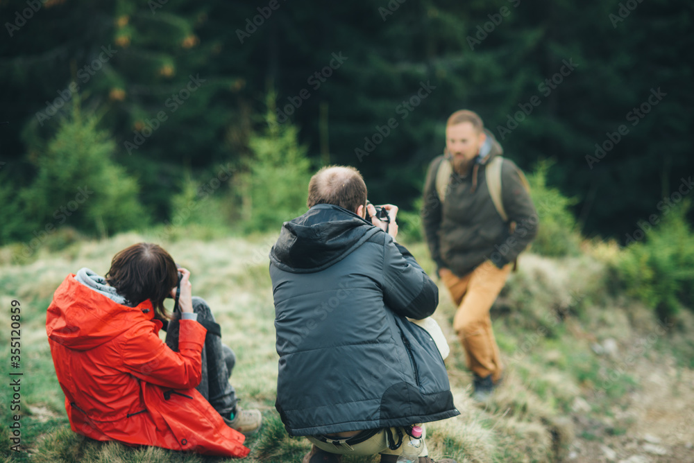 photographers are taking photos in the forest