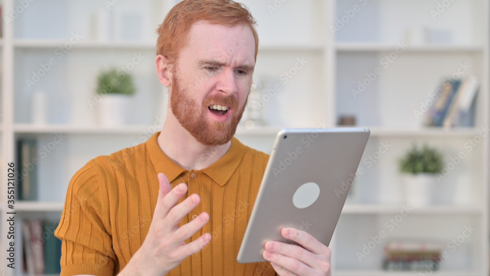 Portrait of Redhead Man Reacting to Loss on Tablet Portrait of Redhead Man Reacting to Loss on Tablet