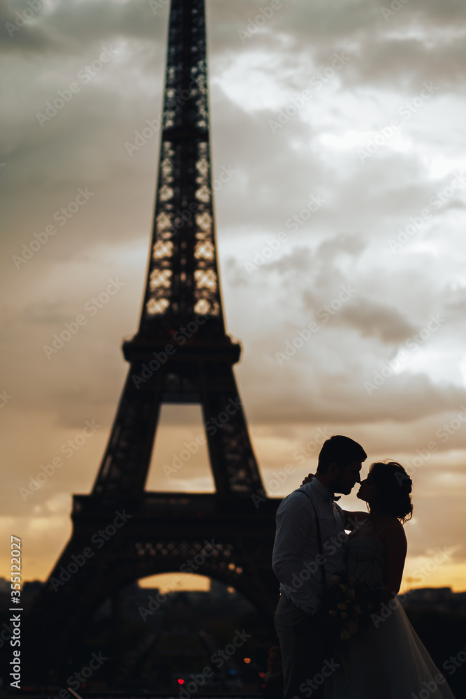 silhouette of lovers at sunset against the background of the Eiffel tower. The moment before the kiss. wedding in Paris