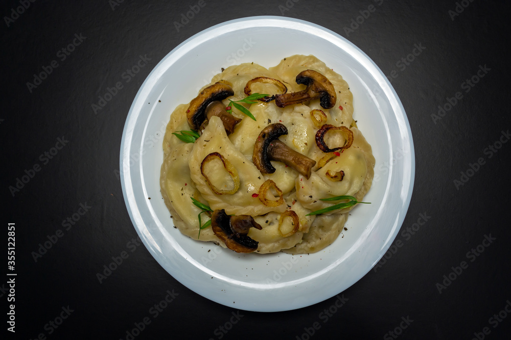 Dumplings with mushrooms, on a black background