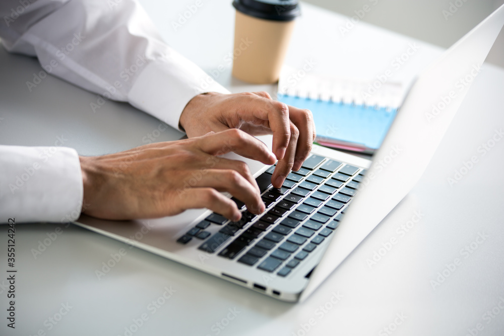 Closeup of businessman's hands working with laptop Closeup of businessman's hands working with laptop