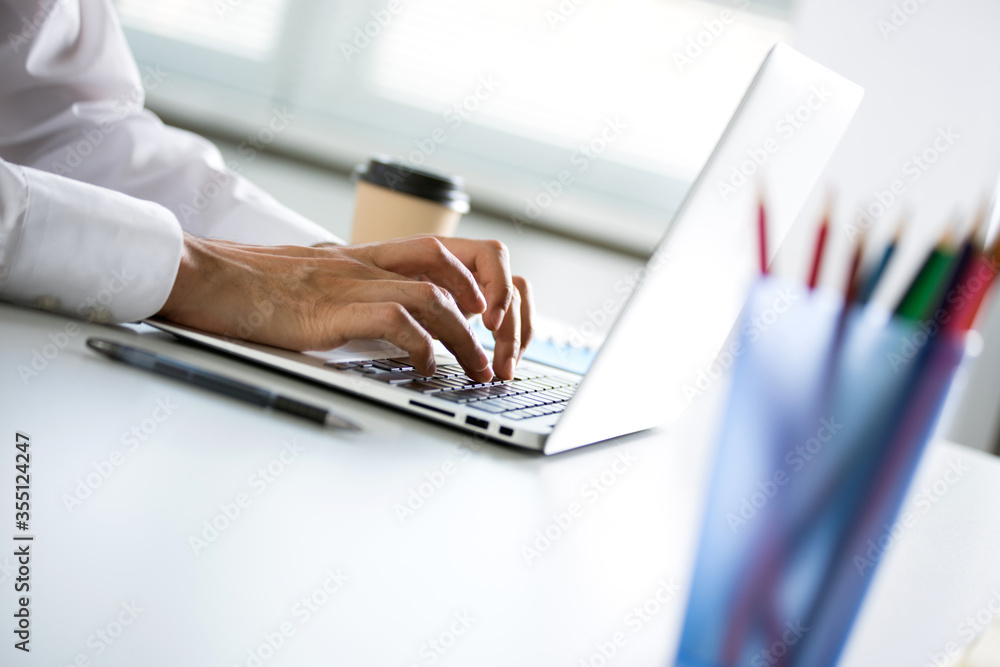 Closeup of businessman's hands working with laptop Closeup of businessman's hands working with laptop