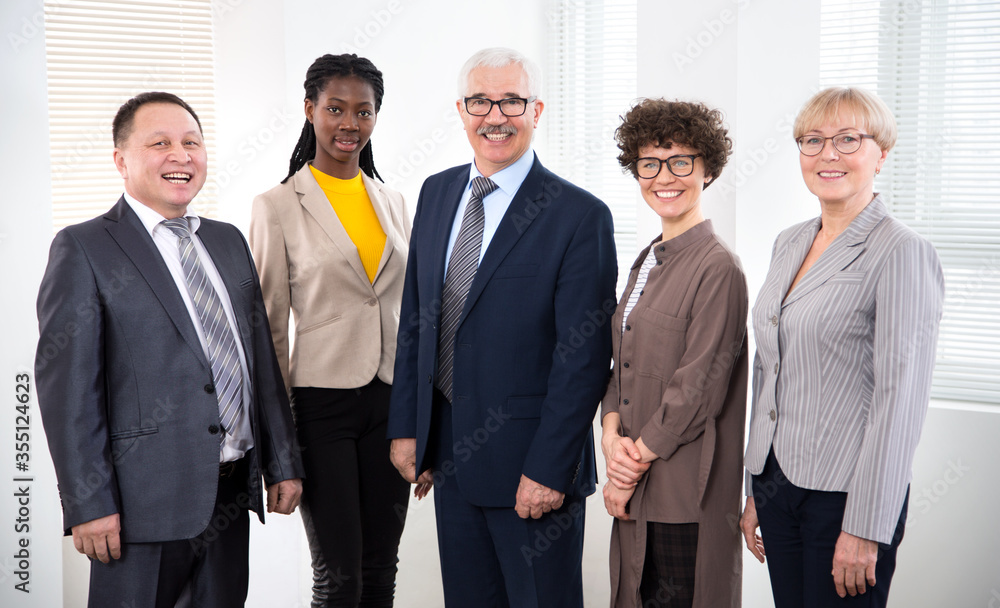 Team of multy-ethnic group of business people smiling at camera Team of multy-ethnic group of business people smiling at camera