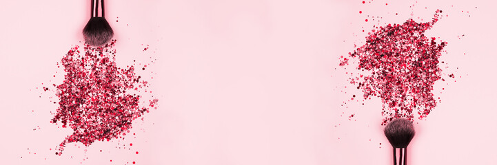 Banner with professional cosmetic makeup brushes with explosion of shiny pink colorful sparkles on pastel pink background with copyspace for your text. Creative make-up concept