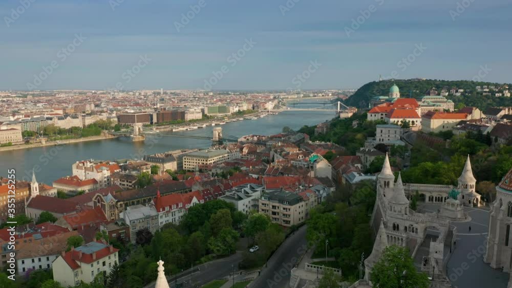 Budapest, Hungary - 4K drone descending by the tower of Fisherman's Bastion on a quiet summer morning with Szechenyi Chain Bridge at background Budapest, Hungary - 4K drone descending by the tower of Fisherman's Bastion on a quiet summer morning with Szechenyi Chain Bridge at background