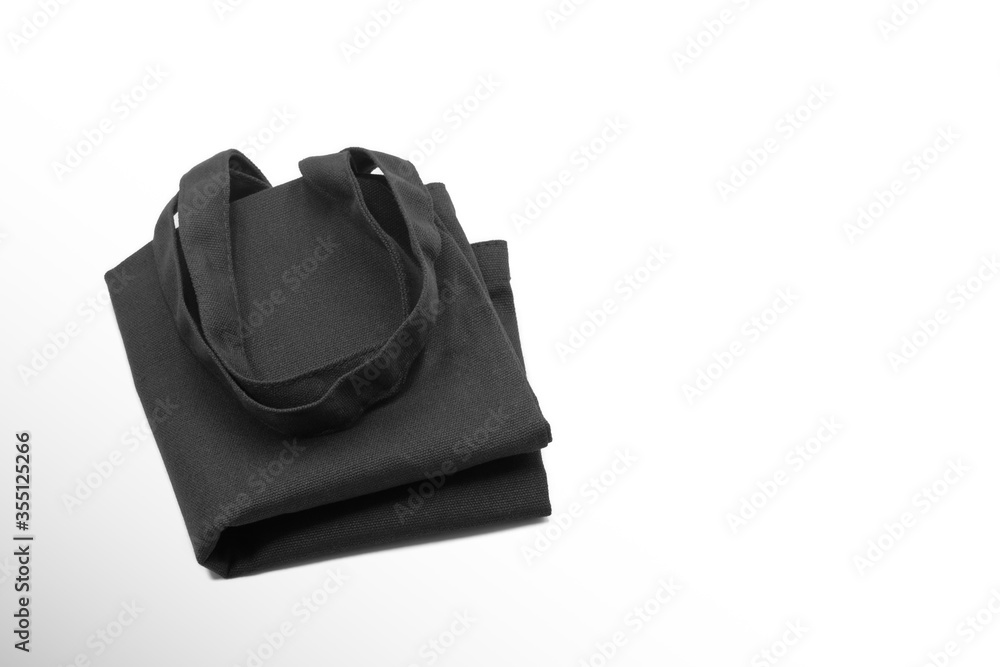 Black cloth bag folded with copy space isolated on white background. Black cloth bag folded with copy space isolated on white background.