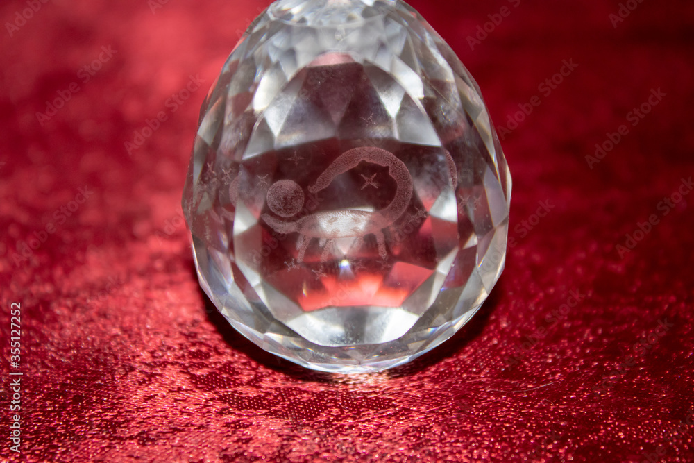 A glass egg with iridescent faces and inside the zodiac sign Scorpio. A glass egg with iridescent faces and inside the zodiac sign Scorpio.