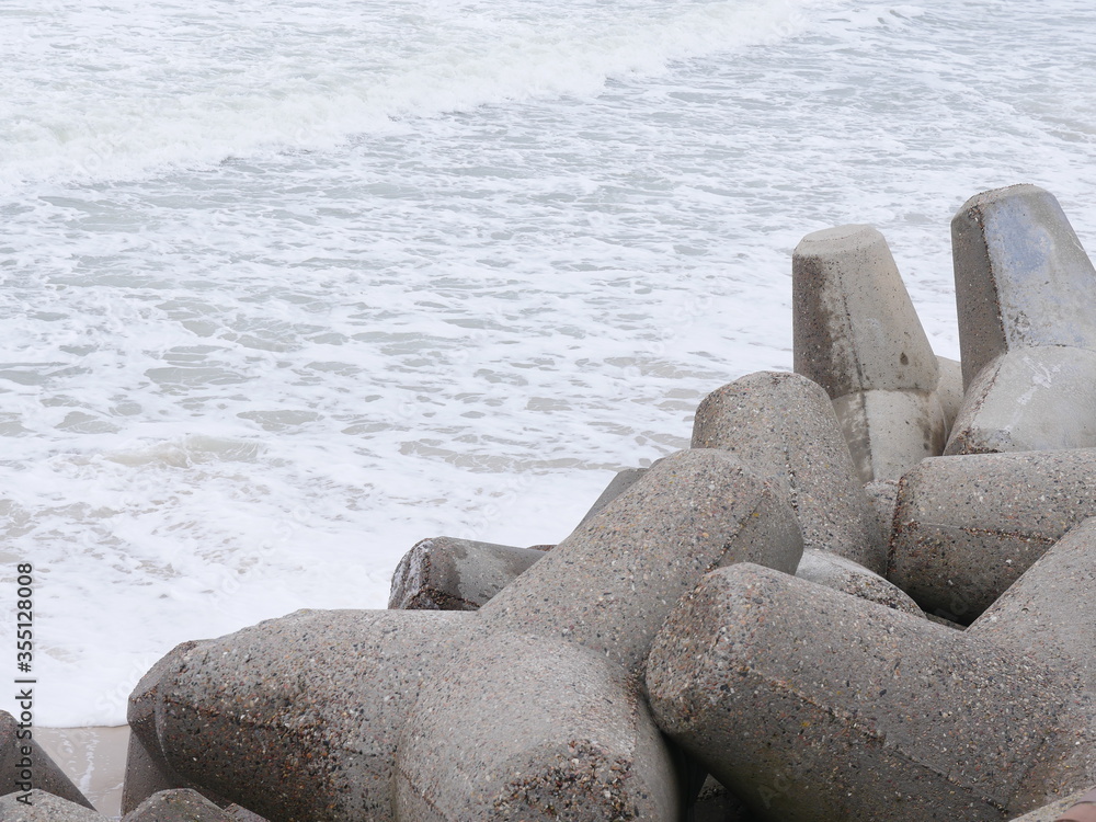 Hacking with three teeth made of concrete, used for coastal protection as security against the surf. Not very pretty but effective, the blocks get stuck and cannot be washed away Hacking with three teeth made of concrete, used for coastal protection as security against the surf. Not very pretty but effective, the blocks get stuck and cannot be washed away