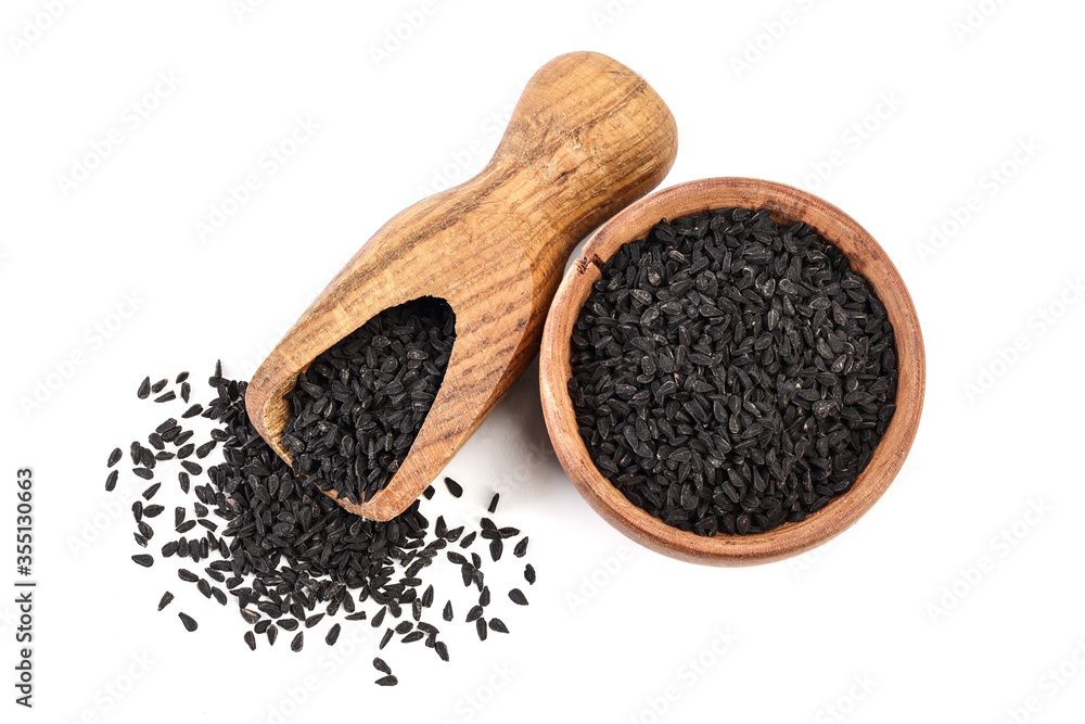 Nigella sativa or Black cumin in wooden bowl isolated on white background. Top view. Flat lay. Nigella sativa or Black cumin in wooden bowl isolated on white background. Top view. Flat lay.
