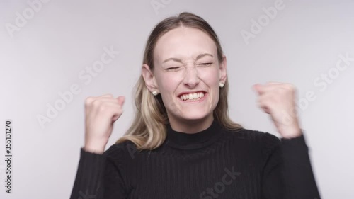 Wallpaper Mural Portrait of a young caucasian blonde woman is very excited, clenches her fists and grabs her face Torontodigital.ca