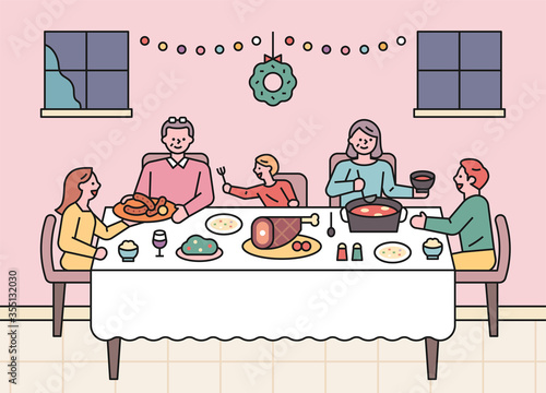 Holiday families are sitting around the table together and having a party.