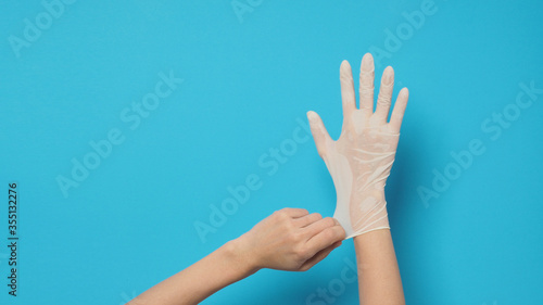 Right hand with white glove and left hand is pulling.Put on blue background.
