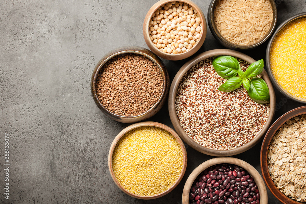 Set with various cereal grains and legumes on stone background Set with various cereal grains and legumes on stone background