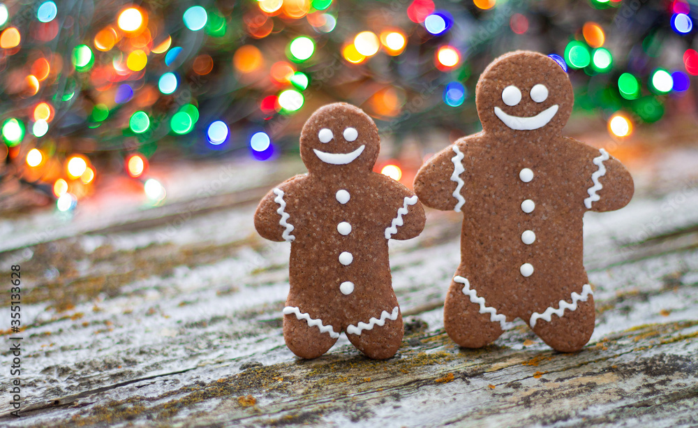 Close-up of christmas gingerbread man family on wooden table with bokeh background Close-up of christmas gingerbread man family on wooden table with bokeh background