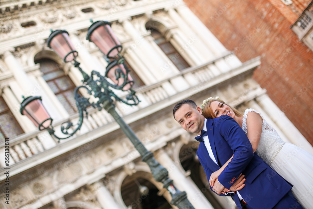 Young wedding couple posing in venice square