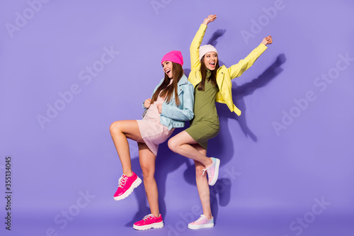 Fototapeta Naklejka Na Ścianę i Meble -  Full length body size view of nice attractive pretty ecstatic cheerful cheery girls dancing having fun celebrating isolated over bright vivid shine vibrant violet lilac purple color background