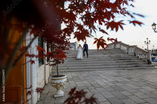 beautiful wedding couple posing on outdoor stairs in venice