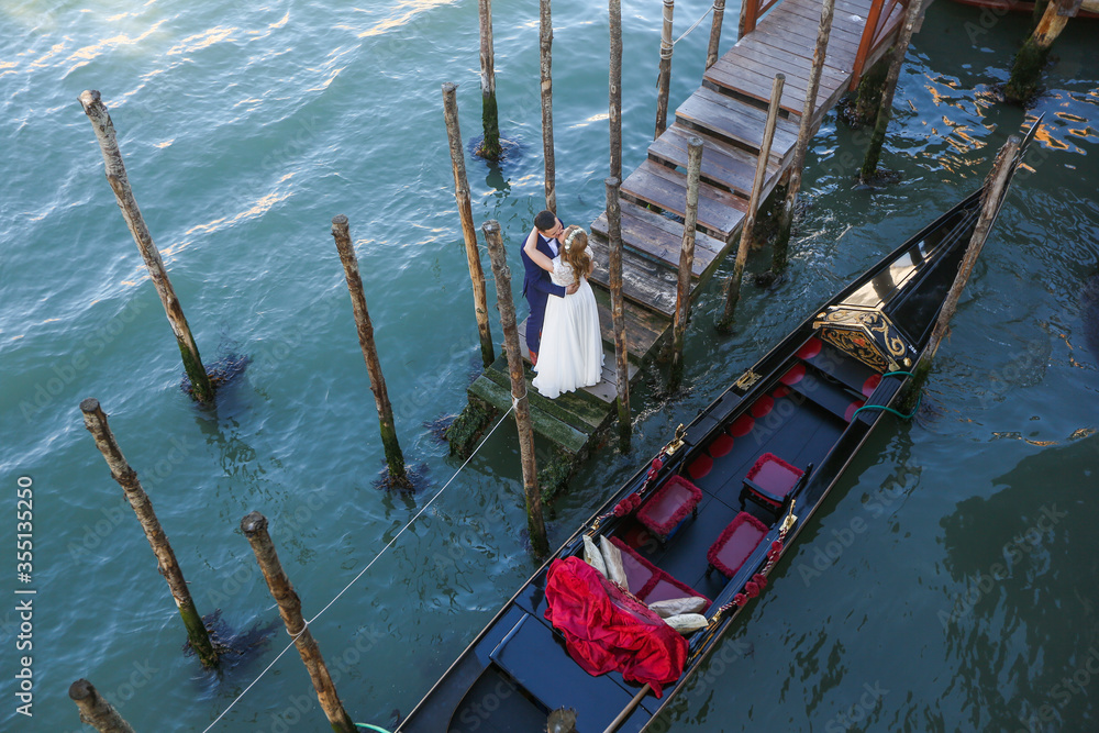 Beautiful wedding couple posing on dock in venice