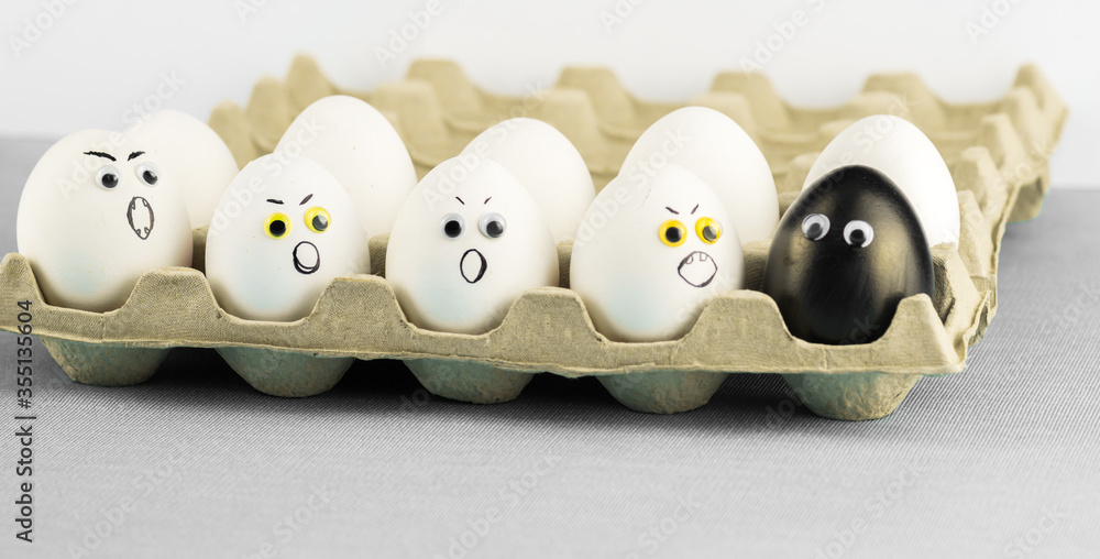 Black egg among angry racist xenophobic white eggs - abstract of anti - racism Black Lives Matter protest in Minneapolis.