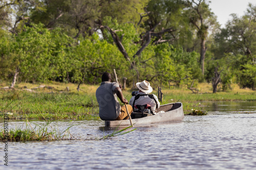 Canoeing  traditional Mokoro boats on the Khwai River in the Moremi Game Reserve Botswana