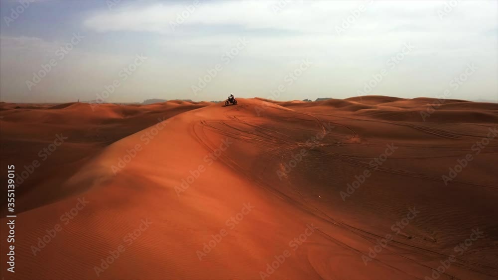 Aerial panorama of Dubai sand desert with driver on bike Aerial panorama of Dubai sand desert with driver on bike