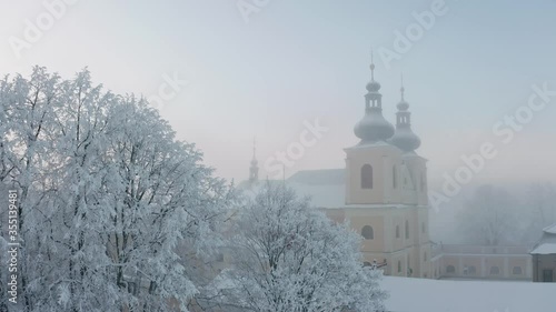 Christian monastery on top of the hill in fog in winter from drone photo