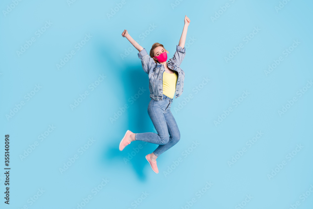 Full body photo of pretty lady quarantine finished rejoicing outdoors jump high street walk good mood spread arms fists up wear face mask blazer jeans shoes isolated blue color background Full body photo of pretty lady quarantine finished rejoicing outdoors jump high street walk good mood spread arms fists up wear face mask blazer jeans shoes isolated blue color background