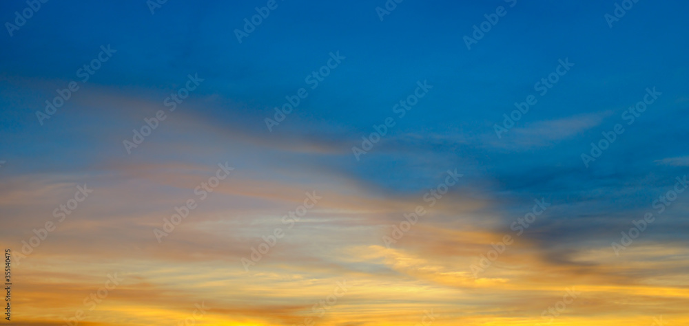 Beautiful sunset. Blue sky and golden clouds. Wide photo