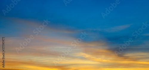 Beautiful sunset. Blue sky and golden clouds. Wide photo