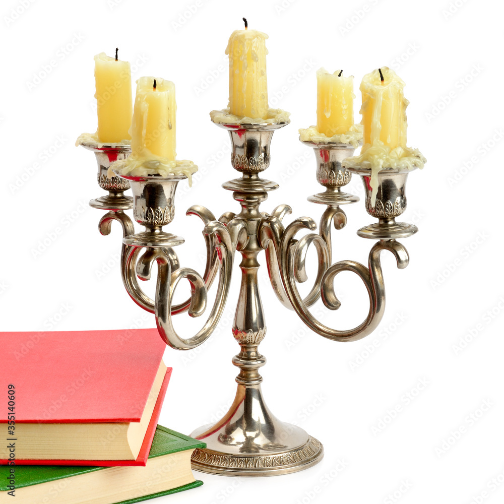 Candlestick with candles and book isolated on white background. Candlestick with candles and book isolated on white background.