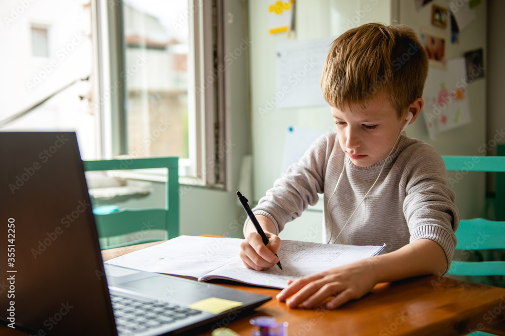 Young boy learning from home, online schooling Young boy learning from home, online schooling