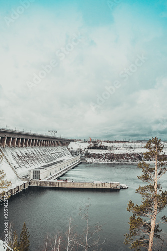 Bratskaya hydroelectric power station in winter in the snow on the Angara river