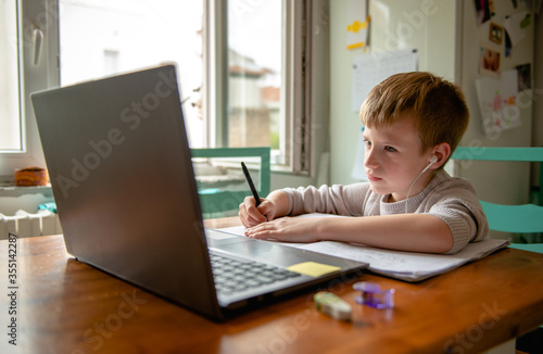 Young boy learning from home, online schooling © Stock Rocket