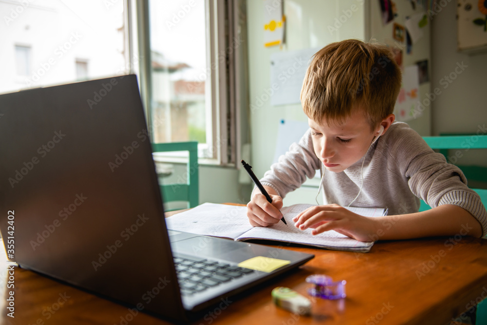 Young boy learning from home, online schooling Young boy learning from home, online schooling