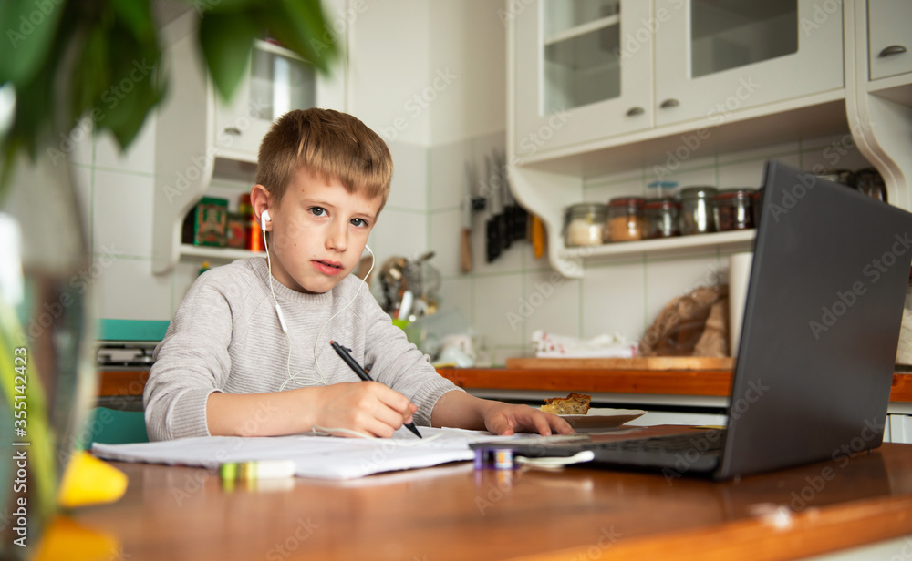 Young boy learning from home, online schooling Young boy learning from home, online schooling