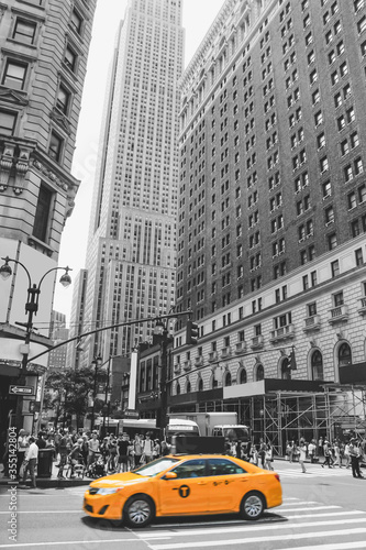 New York City Taxi, with its characteristic yellow color, crossing one of the most popular and tourist areas of the city. Blur Focus Motion