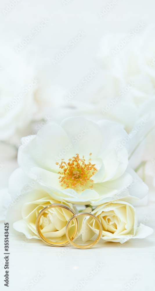 Wedding rings on background of roses