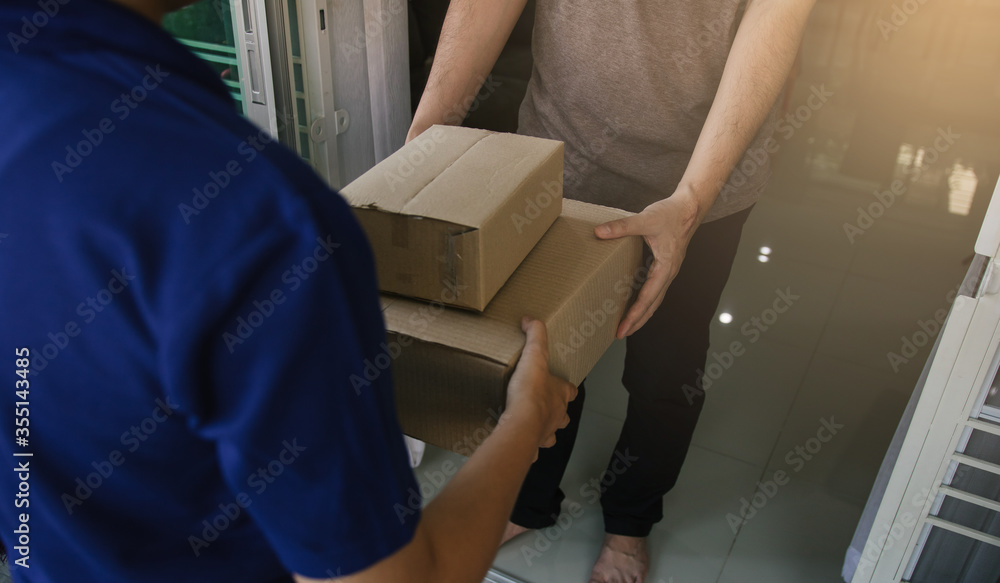 Close up of hands cargo staff are delivering cardboard boxes with parcels inside to the recipient's hand. Close up of hands cargo staff are delivering cardboard boxes with parcels inside to the recipient's hand.
