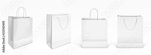 White paper shopping bags front and angle view. Vector realistic mockup of blank packet with handles isolated on white background. Template for corporate design on cardboard bag for store or market